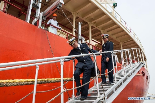 Wang Lianmiao (L) and Zhu Hui leave the Maple Star after the vessel is safely docked at the port of Zhangjiagang in east China's Jiangsu Province, April 24, 2013. (Xinhua/Li Mangmang) 
