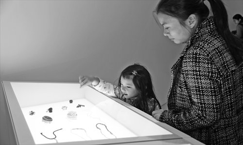 Visitors admire jewelry at the exhibition. Photo: Courtesy of CAFA Art Museum