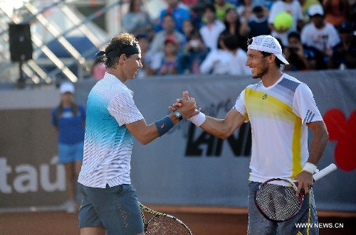Spanish tennis player Rafael Nadal (L) greets Argentine Juan Monaco (R) during an ATP Vina del Mar tournament doubles match against Czech Republic's Frantisek Cermank and Lukas Dlouhy in Vina del Mar, Valparaiso Region, Chile, Feb. 5, 2013. (Xinhua/Jorge Villegas) 