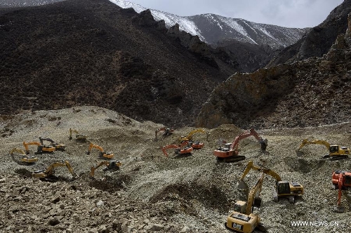 Rescue workers conduct search and rescue work at the site where a large-scale landslide hit a mining area in Maizhokunggar County of Lhasa, southwest China's Tibet Autonomous Region, March 30, 2013. Rescuers have found bodies and are still searching for survivors more than 37 hours after a massive landslide buried 83 miners at the polymetal mine in Tibet. (Xinhua/Chogo)