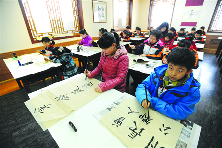 Students at a primary school in Shenyang, Liaoning Province study calligraphy on March 11, 2013. Photo: CFP