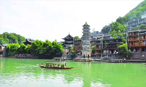 Tourists visit Fenghuang, an ancient water town in Hunan Province. With the peak tourist season looming, the scenic area of the town ended its free-admission period Wednesday, when it began charging 148 yuan ($24) for a one-day pass. Photo: CFP 