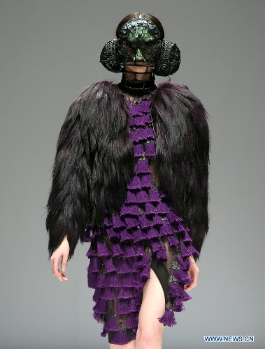 A model presents a creation designed by students from China Academy of Art during the 1st China Graduate Fashion Week in Beijing, capital of China, April 24, 2013. A total of 610 graduate students from 22 universities will present their designs during the five-day event which kicked off on Wednesday. (Xinhua/Chen Jianli)