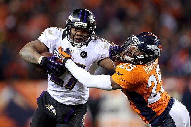 Ray Rice (left) of the Baltimore Ravens stiff-arms Chris Harris of the Denver Broncos as he runs the ball on Saturday. Photo: AFP