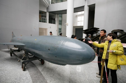 Tourists visit a missile at the weapon museum of Nanjing University of Science and Technology (NJUST) in Nanjing, capital of east China's Jiangsu Province, March 24, 2013. The NJUST opened to public to celebrate its 60th anniversary Sunday. The weapon museum collects about 6,000 weapons since the First World War. (Xinhua)&nbsp; 