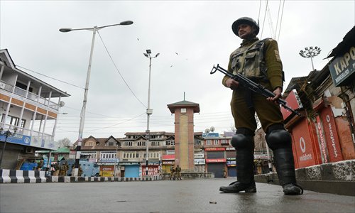 An Indian paramilitary soldier keeps watch during a curfew, imposed Thursday on Srinagar, the capital of India-controlled Kashmir. The curfew was imposed following the killing of a 22-year-old local resident by the Central Reserve Police Force, which many in Kashmir believe was a reprisal killing in response to the Wednesday attack that resulted in the deaths of five paramilitary personnel. Photo: AFP
