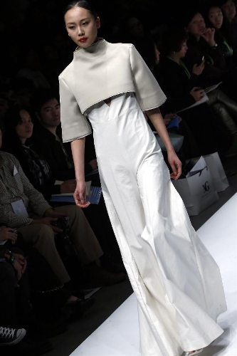 A model presents a creation designed by students from the Sino-French Institute of Fashion Designer in Shanghai University of Engineering Science during the first China Graduate Fashion Week in Beijing, capital of China, April 24, 2013. A total of 610 graduate students of fashion from 22 colleges will present their designs during the five-day event which kicked off on Wednesday. (Xinhua/Li Mingfang) 