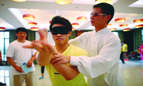 Zheng Yuankang, a former disciple of Master Wan now working as his assistant, directs a student at a training center in Beijing. Photo: IC