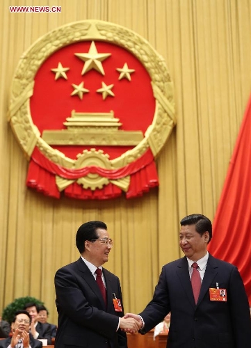   Hu Jintao (L) congratulates Xi Jinping at the fourth plenary meeting of the first session of the 12th National People's Congress (NPC) in Beijing, capital of China, March 14, 2013. Xi was elected president of the People's Republic of China (PRC) and chairman of the Central Military Commission of the PRC at the NPC session here on Thursday. (Xinhua/Lan Hongguang)