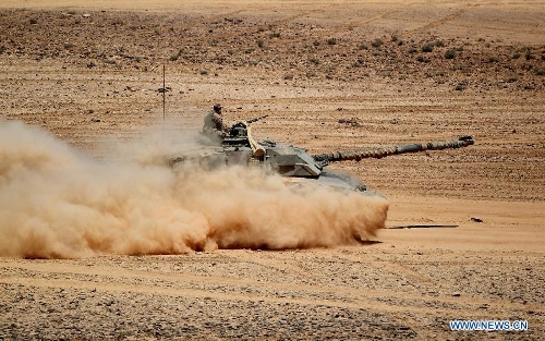 A U.S. tank participates in the Eager Lion military exercise, at the Quweira city, 290km south of Amman, Jordan, June, 19, 2013. The 12-day exercise involves combined air, land and sea maneuvers across Jordan. Along with Jordan and the U.S., the exercise brings together some 8,000 personnel from 19 Arab and European nations to train on border security, irregular warfare, anti-terrorism and counterinsurgency. (Xinhua/Mohammad Abu Ghosh) 