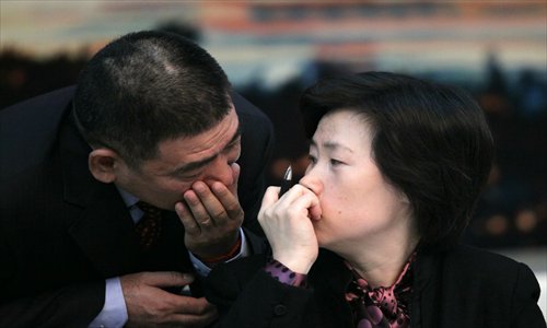 Two deputies to the National People's Congress from Southwest China's Chongqing Municipality talk to each other Wednesday during the two sessions in Beijing. Photo: CFP