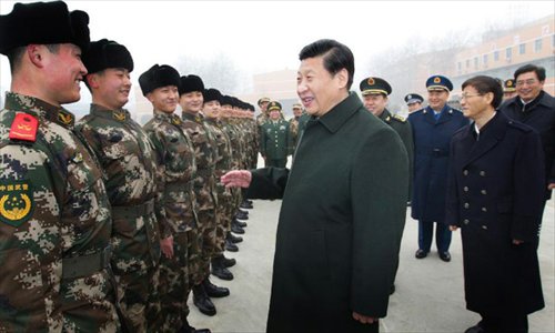 Xi Jinping (C, front), general secretary of the Central Committee of the Communist Party of China (CPC) and also chairman of the CPC Central Military Commission, talks with members of the 13th detachment of the Beijing contingent of Chinese People's Armed Police Force in Beijing, capital of China, January 29, 2013. Xi made an inspection tour in the armed police forces in Beijing on Tuesday to convey festival greetings to the nation's armed policemen on behalf of the CPC Central Committee, the State Council and the Central Military Commission.