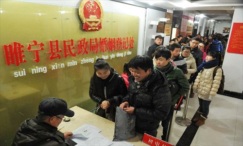 Couples wait in queue to register at the marriage registration office in Suining county, East China's Jiangsu Province, January 4, 2013. Many couples here flocked to tie the knot on January 4, 2013, or 2013/1/4, which sounds like 
