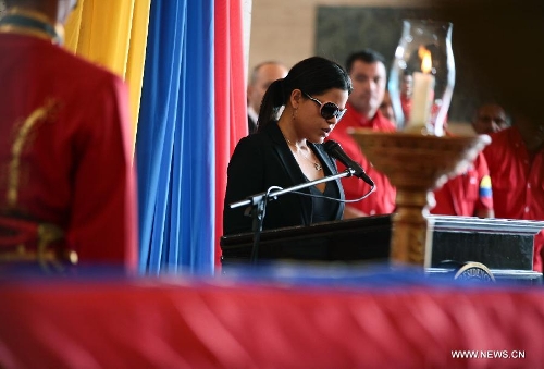 Maria Gabriela Chavez delivers a speech in front of the body of late Venezuelan President Hugo Chavez during a honor ceremony at the Military Academy's fire chapell, prior to his carrying from the Military Academy to the Mountain Barracks, in the city of Caracas, capital of Venezuela, on March 15, 2013. Hundreds of thousands of Venezuelans Friday marched alongside the casket of their late President Hugo Chavez, as his remains were taken to the mountaintop barracks he once called home and today houses the Historic Military Museum. (Xinhua/AVN)