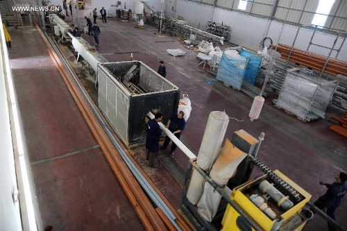 Palestinian workers are seen at the only factory to manufacture sewage pipes at Karni industrial zone in northern Gaza Strip on March 12, 2013. (Xinhua/Wissam Nassar