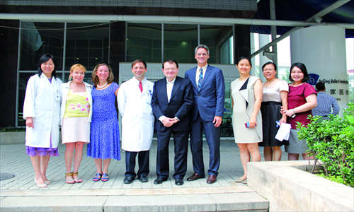 Luc Montagnier (middle) with employees from BJU. 
Photo: Courtesy of Beijing United Family Hospital