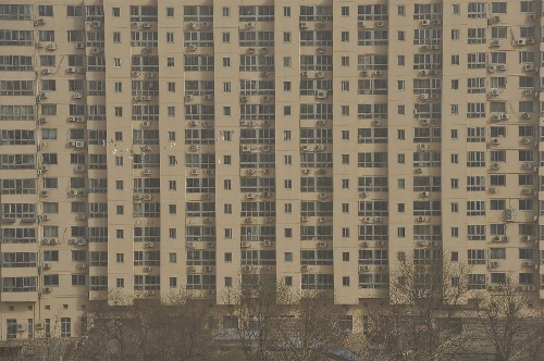 A flock of pigeons fly in front of a building in sandy air in Beijing, capital of China, March 9, 2013. A cold front brings strong wind as well as sand and dust to Beijing on March 9. (Xinhua/Lu Peng) 