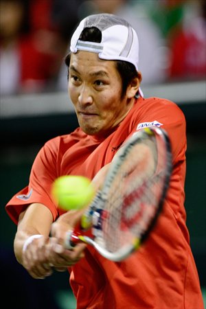 Tatsuma Ito of Japan returns a shot against Cho Min-hyeok of South Korea during their singles match in the second round of the Davis Cup Asia/Oceania Zone Group I tennis tournament in Tokyo on Sunday. Photo: AFP