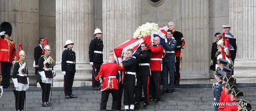 The coffin of British former prime minister Margaret Thatcher is carried out of St. Paul's Cathedral following the ceremonial funeral service in London, Britain, April 17, 2013. The funeral of Margaret Thatcher, the first female British prime minister, started 11 a.m. local time on Wednesday in London. (Xinhua/Yin Gang)