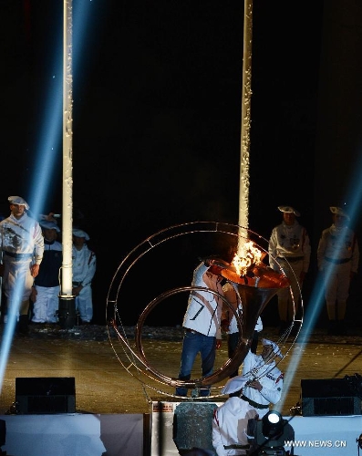 The flame torch is lit during the opening ceremony of the 2nd International Military Sports Council(CISM) World Winter Games at Annecy, France, March 25, 2013. (Xinhua/Wang Siwei) 