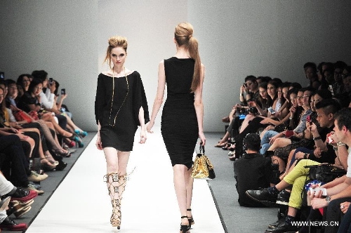 Models present creations of Dubai based label GisellaBlu's evening and party wear collection at the Audi Fashion Festival held in Singapore's Marina Bay, May 17, 2013. (Xinhua/Then Chih Wey) 