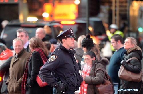 A policeman patrols at the Times Square in New York, the United States, Jan. 16, 2013. New York State Governor Andrew Cuomo on Tuesday signed the NY Safe Act following the Assembly has voted overwhelmingly in favor of the bill, which was seen as the toughest gun control law in the nation and the first since the Newtown school shooting. (Xinhua/Wang Lei)