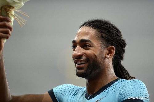 Jason Richardson of the United States waves to the audience after winning the men's 110m hurdles during the IAAF Diamond League Athletics meet in Shanghai, east China, May 18, 2013. Richardson won the first place of the event in 13.23 seconds.(Xinhua/Li Jundong) 