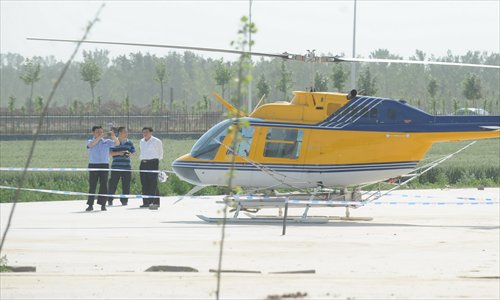 Police impound a helicopter at an airport in Pingyuan county on Wednesday after a dispute between rival companies. Photo: CFP