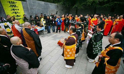 Chinese and Japanese monks attend a religious service at the Memorial Hall of the Victims in Nanjing Massacre by Japanese Invaders in Nanjing, capital of east China's Jiangsu Province, December 13, 2012, to mark the 75th anniversary of the Nanjing Massacre. Nanjing was occupied on December 13, 1937, by Japanese troops who began a six-week massacre. Records show more than 300,000 Chinese unarmed soldiers and civilians were killed. Photo: Xinhua
