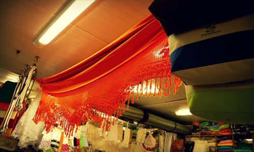A hammock hangs on display in a market 