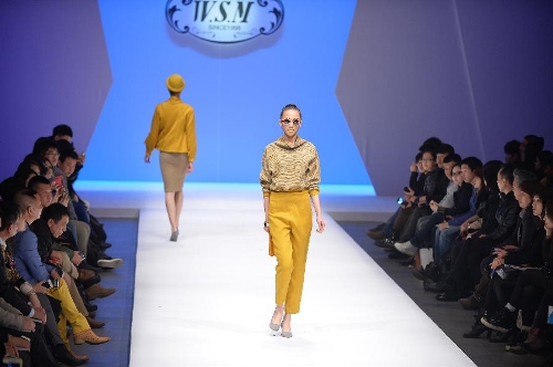 A model presents a creation in the WSM China Knitwear Fashion Design Contest 2013 during the China Fashion Week in Beijing, capital of China, March 26, 2013. The design by Sheng Lina from Fashion School & Engineering of Zhejiang Sci-Tech University won the championship of the contest. (Xinhua/Li Xin) 