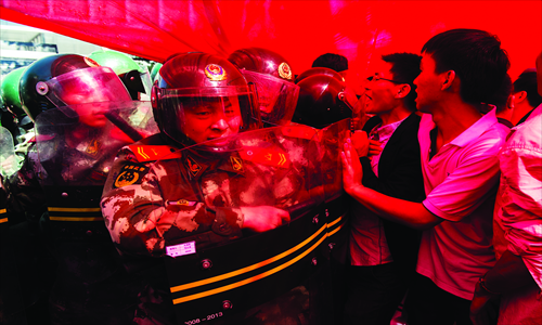 Protesters face armed police in front of the Japanese embassy in Beijing on Saturday. Photo: Li Hao/GT