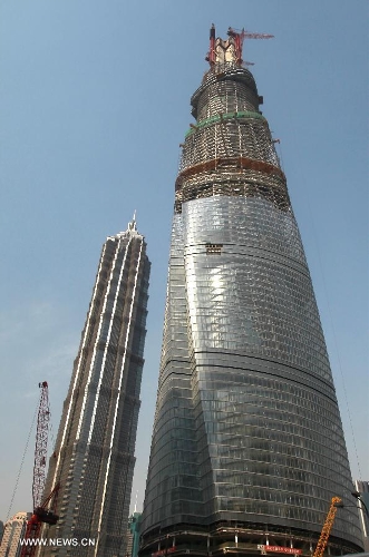 Photo taken on April 11, 2013 shows the Shanghai Tower (R) under construction in east China's Shanghai Municipality. The height of the Shanghai Tower, which is still under construction, reached 501.3 meters Thursday, surpassing the neighbouring Jinmao Tower and the World Financial Center. The designed height of the Shanghai Tower will be 632 meters, the tallest skyscraper in China. (Xinhua/Pei Xin)&nbsp;