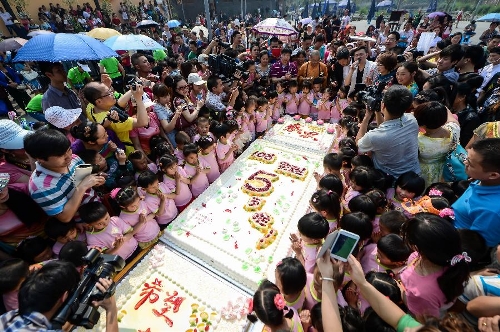 A birthday party is held at the Luohan Temple in Shifang City, southwest China's Sichuan Province, May 12, 2013. The birthday party was held for 108 children, who were born at the Luohan Temple five years ago after the devastating earthquake jolted Wenchuan County of Sichuan on May 12, 2008. The temple then was used as a temporary obstetrics hospital from May 13 to Aug. 7 in 2008 to deliver newborn babies. A total of 108 babies were born at the temple until the local maternal and child health care hospital reopened. (Xinhua/Jiang Hongjing) 