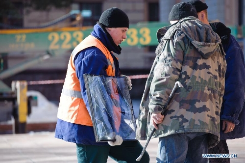 Workers replace a window damaged by the shockwave of the meteorite fall in Chelyabinsk, Russia, Feb. 16, 2013. Life in Russia's Chelyabinsk Region returns to normal after Friday's meteorite explosion as residents start to cover smashed windows with Cellophane sheets to keep warm. About 1,200 people have been known injured and many buildings damaged since a meteor exploded on Friday morning, raining fireballs over Russia's central Urals region, the Interior Ministry said. (Xinhua/Jiang Kehong)