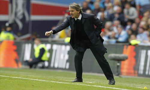 Then manager of Manchester City Roberto Mancini gestures during the FA Cup Final between Manchester City and Wigan Athletic at Wembley Stadium in London on May 11. Photo: AFP