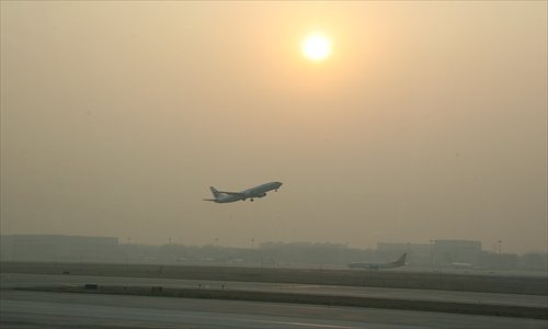 A plane takes off at Beijing Capital International Airport. The airport will adopt new ways of habitat reduction to make the airport less attractive to birds, and thus prevent potentially deadly bird strikes. Photo: Peter C Espina/GT