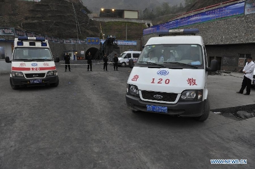 Medical workers wait at the site of the accident in Shuicheng County, southwest China's Guizhou Province, March 13, 2013. Twenty-one miners were killed and four others were missing in a coal and gas outburst Tuesday evening at Machang Coal Mine which belongs to Gemudi Company of Guizhou Water & Mining Group. Eighty-three miners were working underground when the accident took place, and 58 of them managed to get to the ground safely. (Xinhua/Ou Dongqu) 