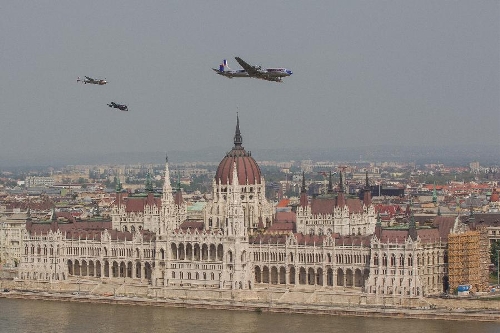 Airplanes fly in front of the Hungarian Parliament during an air show above river Danube crossing central Budapest, Hungary, on May 1, 2013. (Xinhua/Attila Volgyi) 