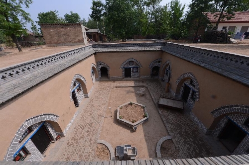 Photo taken on May 18, 2013 shows a renovated sunken courtyard in Qucun Village of Zhangbian Township in Shaanxian County, central China's Henan Province. The sunken courtyard, a kind of traditional residential construction in west Henan, has a high value in the study of local histroy, architecture, geology and sociology. The Qucun Village has 115 sunken courtyards, most of which are under protective reconstruction. (Xinhua/Zhao Peng)