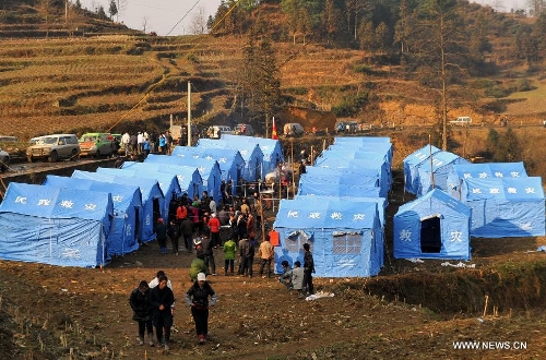 Photo taken on Jan. 12, 2013 shows tents installed for landslide-affected villagers at Gaopo Village in Zhenxiong County, southwest China's Yunnan Province. Landslide-affected villagers in Gaopo Village have been temporarily settled in tents and got life necessities. Forty-six people were killed in the Friday landslide. Another two people were injured. (Xinhua/Chen Haining) 