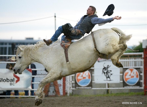 Bobby Peters of Canada competes in Bareback Riding category at the annual Cloverdale Professional Rodeo 2013 in Cloverdale, BC, Canada, May 17, 2013. In 1984 the Cloverdale Rodeo was voted the Number One Performance Rodeo in North America by the Professional Rodeo Cowboy's Association. Today the Cloverdale Rodeo & Exhibition is the second largest community rodeo in Canada, attracting competitors and spectators worldwide. (Xinhua/Sergei Bachlakov) 
