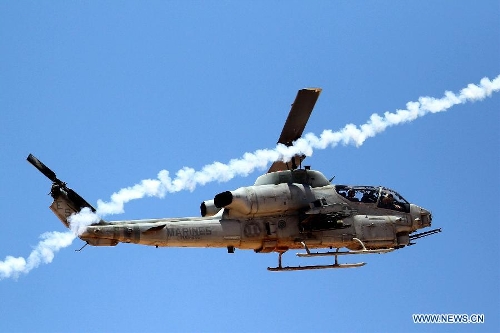 A U.S. helicopter fires during the Eager Lion military exercise, at the Quweira city, 290km south of Amman, Jordan, June, 19, 2013. The 12-day exercise involves combined air, land and sea maneuvers across Jordan. Along with Jordan and the U.S., the exercise brings together some 8,000 personnel from 19 Arab and European nations to train on border security, irregular warfare, anti-terrorism and counterinsurgency. (Xinhua/Mohammad Abu Ghosh) 