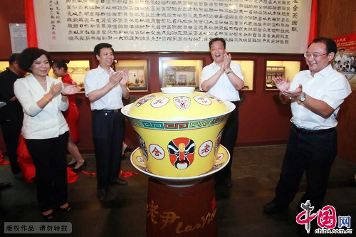 A 200kg ceramic tea bowl debuted June 30 at the Laoshe Teahouse, a world-famous Chinese folk teahouse in Beijing. The huge bowl, an enlarged version of the classical ceramic bowls with yellow lids used at the teahouse, was made by craft masters in Jingdezhen, which is known as the Porcelain Capital of China. The 75x88 cm-bowl is currently the biggest of its kind in the world. Its makers have applied to have it listed in the Guinness Book of World Records. The party at which the bowl debuted was held to mark the tenth anniversary of the death of teahouse founder Yin Shengxi.(Photo:China.org.cn)