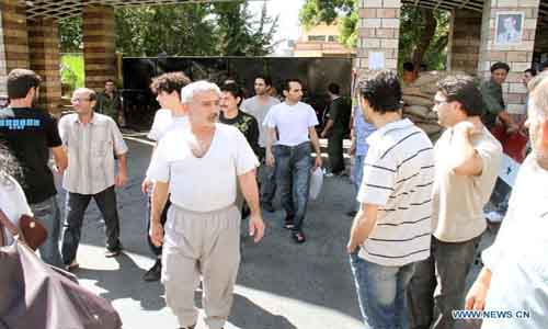 Prisoners walk out of the headquarters of the Police Command in Damascus, Syria, September 9, 2012. Dozens of prisoners have been released from Syrian jails on Sunday as part of the government's reform program. Syria says those who were released didn't take part in bloody events in the country and their hands were clean from the Syrians' blood. Hundreds of prisoners were released over the past few weeks in different cities and provinces. Photo: Xinhua