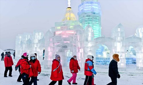 Tourists walk around at the 29th Harbin International Ice and Snow Festival in Harbin, capital of northeast China's Heilongjiang Province, December 23, 2012. The festival kicked off at the Harbin Ice and Snow World on Sunday. Photo: Xinhua