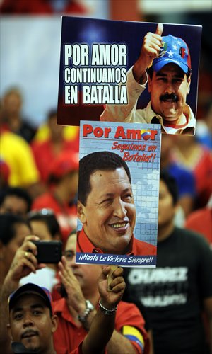 Supporters of Venezuelan acting president Nicolas Maduro cheer before the start of a campaign rally in the state of Barinas, Venezuela on Saturday, ahead of the presidential election on April 14. Photo: AFP