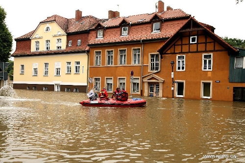 Workers carry out search and rescue operation in a hovercraft on the flooded street in Halle, eastern Germany, on June 4, 2013. The water level of Saale River across Halle City is expected to rise up to its historical record of 7.8 meters in 400 years, due to persistent heavy rains in south and east Germany. (Xinhua/Pan Xu)  