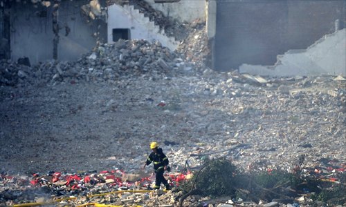 A rescuer walks among the debris from an explosion in the Ezhangtan area of Baiyun district, Guangzhou, Guangdong Province on Tuesday. Photo: CFP