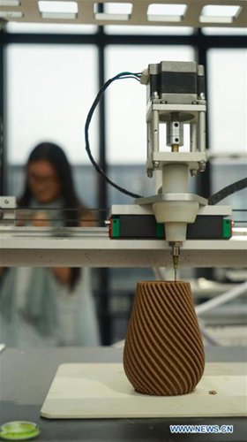 A 3D printer works on a pottery craftwork in Jingdezhen, east China's Jiangxi Province, Oct. 19, 2016. (Photo/Xinhua)